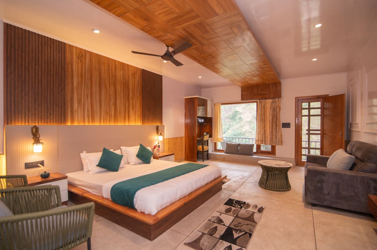 Signature suite with teal sofa and balcony